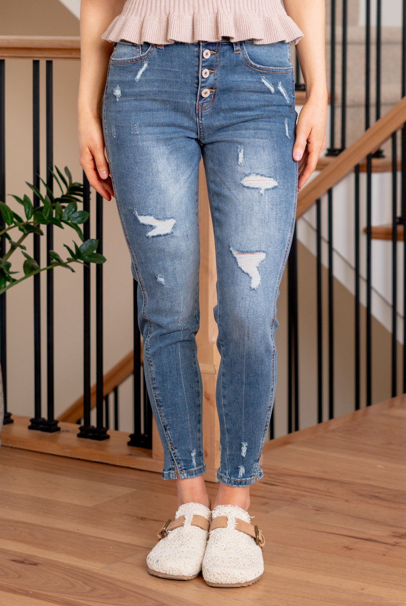 KanCan Jeans Introducing the Ellington High-Rise Ankle Skinny Jeans, your go-to classic skinnies for any occasion. These jeans strike the perfect balance with just the right amount of distress, slit hems, and fading and whiskering details for that lived-in appeal. The classic five-pocket design ensures practicality, and the button fly closure adds a timeless touch. Complete with silver-colored hardware, these jeans are ready to be dressed up or down, making them a versatile addition to your wardrobe.