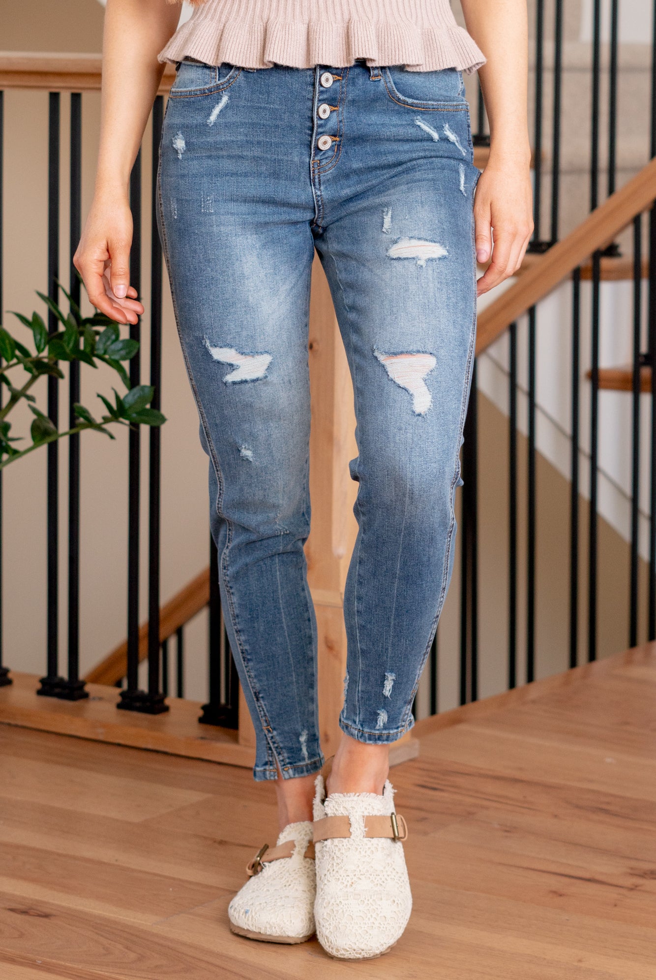 KanCan Jeans Introducing the Ellington High-Rise Ankle Skinny Jeans, your go-to classic skinnies for any occasion. These jeans strike the perfect balance with just the right amount of distress, slit hems, and fading and whiskering details for that lived-in appeal. The classic five-pocket design ensures practicality, and the button fly closure adds a timeless touch. Complete with silver-colored hardware, these jeans are ready to be dressed up or down, making them a versatile addition to your wardrobe.