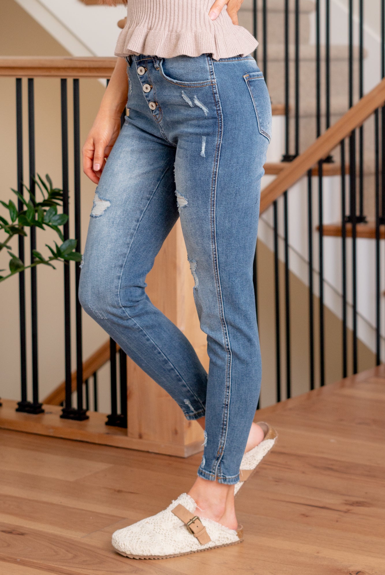KanCan Jeans Introducing the Ellington High-Rise Ankle Skinny Jeans, your go-to classic skinnies for any occasion. These jeans strike the perfect balance with just the right amount of distress, slit hems, and fading and whiskering details for that lived-in appeal. The classic five-pocket design ensures practicality, and the button fly closure adds a timeless touch. Complete with silver-colored hardware, these jeans are ready to be dressed up or down, making them a versatile addition to your wardrobe.