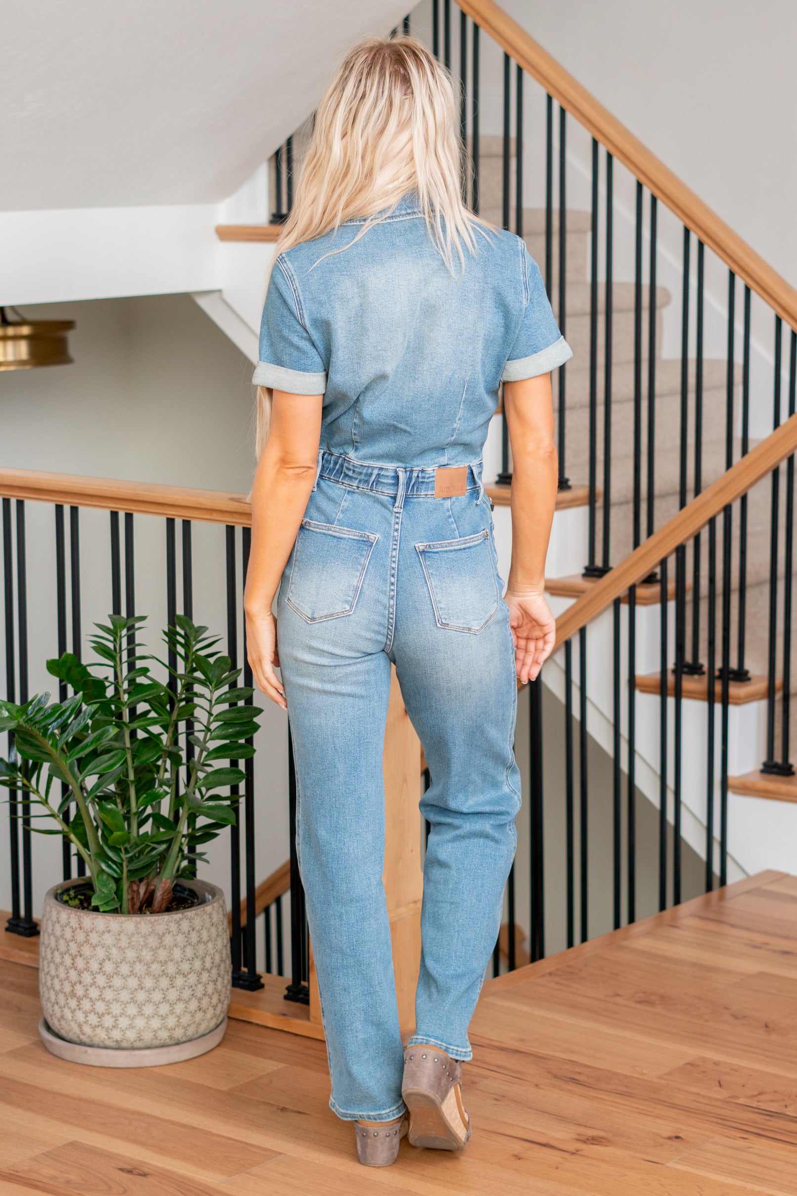 Judy Blue This jumpsuit features a flattering high waist and a chic straight fit, complemented by a medium wash for a timeless look. Embrace both fashion and functionality in this on-trend piece designed for ultimate comfort and style. Elevate your wardrobe with the Aspen jumpsuit, the ideal choice for a stylish and confident statement. Color: Medium Wash Cut: Straight, 32" Inseam* Rise: -Rise, 14" Front Rise* Material: 94% Cotton / 5% Polyester / 1% Spandex Stitching: Classic Fly: Zipper Style #: 88722PL