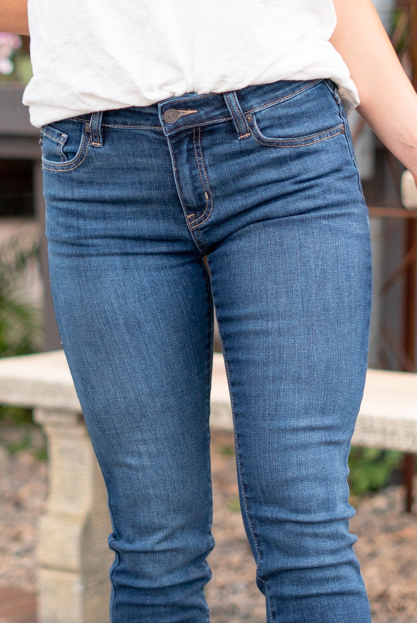 KanCan Jeans Color: Dark Wash Cut: Skinny, 27" Inseam* Rise: Mid-Rise, 9" Front Rise* 74% COTTON, 10% RAYON, 15% POLYESTER, 1% SPANDEX Stitching: Classic Fly: Zipper Style #: KC20009D Contact us for any additional measurements or sizing. *Measured on the smallest size, measurements may vary by size. Jacquelyn wears a size 25 in jeans, a small in tops, and 6.5 in shoes. She is wearing size 25 in these jeans.