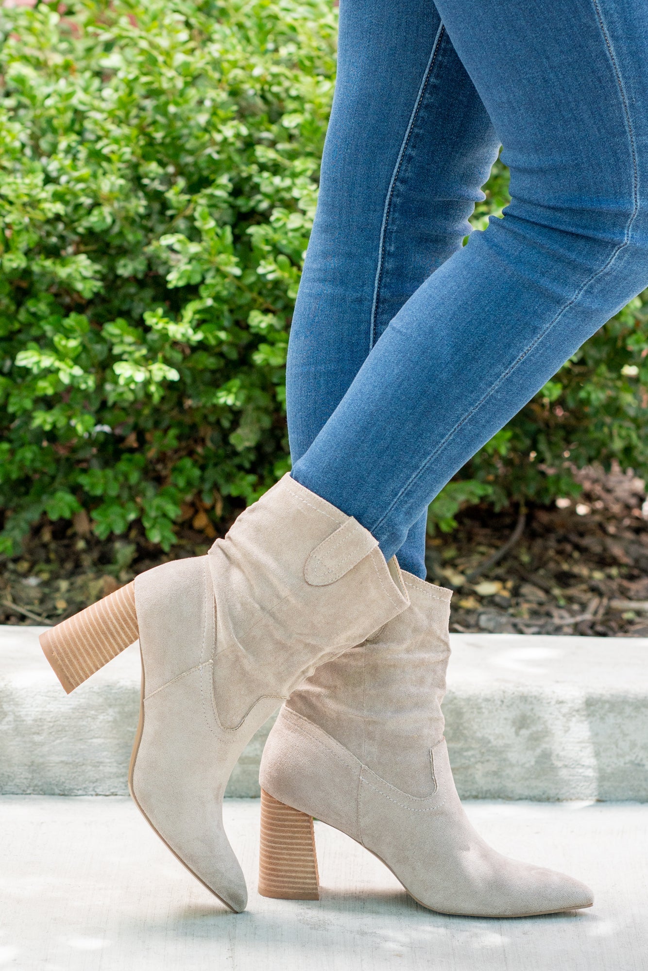 Boots by Oasis Society This city-slick cowboy-style bootie kicks it up a notch with a bold stacked heel. Crafted from manmade suede, this upper is completed with a slight slouch in the ankle. Finished on our signature padded footbed, they're a must for all day comfort. Man-made Upper Color: Taupe Padded footbed Shaft Height: 5.75" Heel Height: 3.25" Opening: 12" Contact us for any additional measurements or sizing.