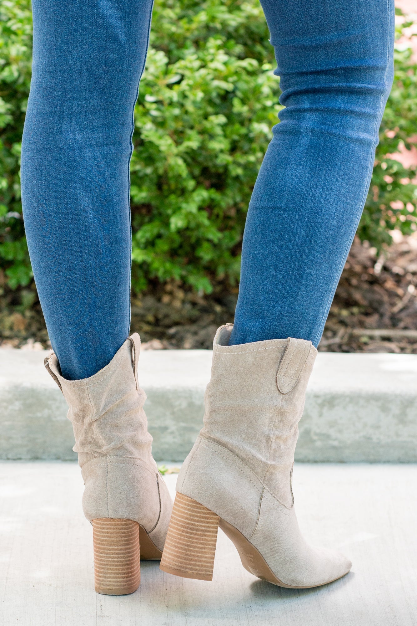 Boots by Oasis Society This city-slick cowboy-style bootie kicks it up a notch with a bold stacked heel. Crafted from manmade suede, this upper is completed with a slight slouch in the ankle. Finished on our signature padded footbed, they're a must for all day comfort. Man-made Upper Color: Taupe Padded footbed Shaft Height: 5.75" Heel Height: 3.25" Opening: 12" Contact us for any additional measurements or sizing.