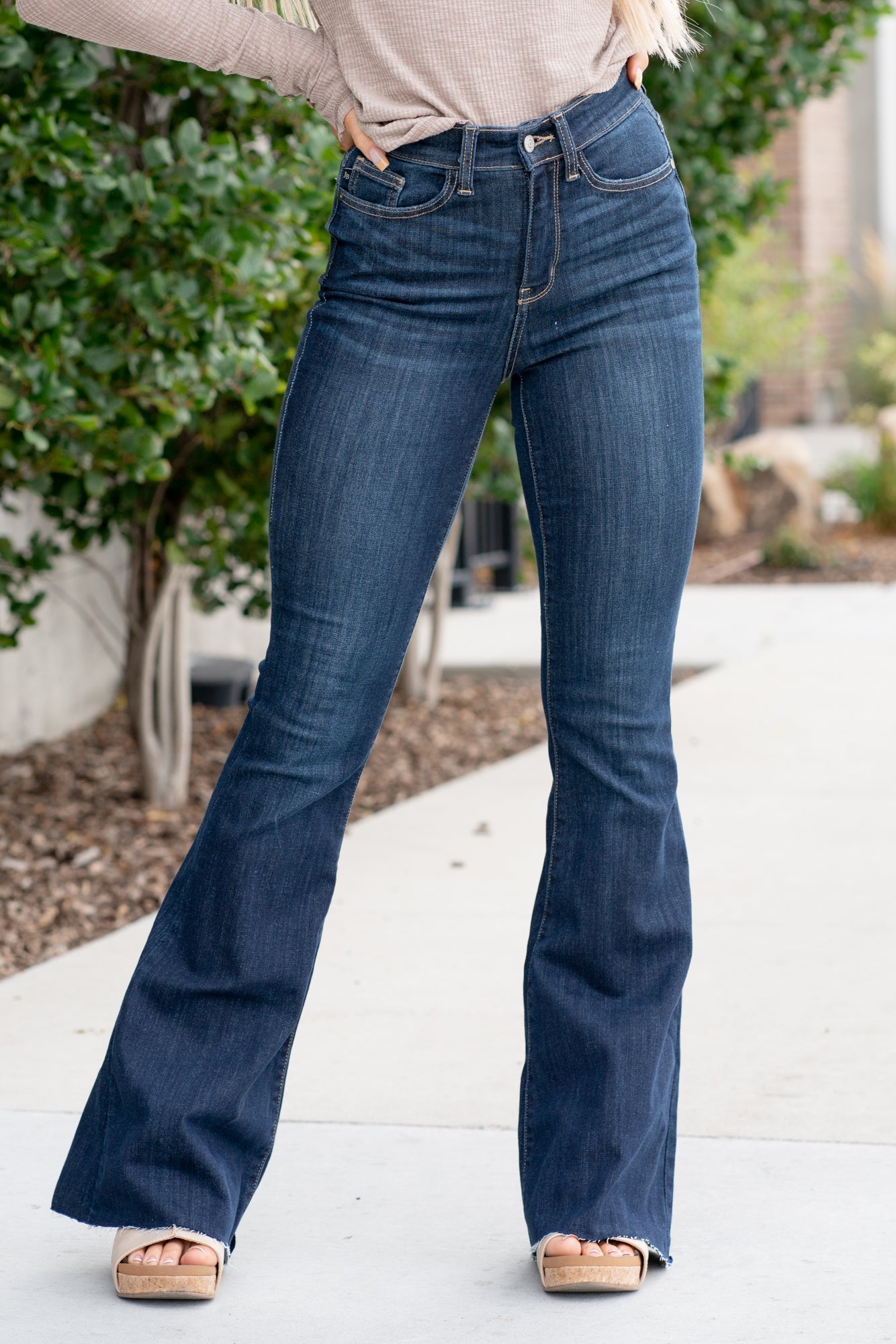Judy Blue Don't be afraid to wear high-waisted jeans, especially these flares. With a dark blue wash and a cut hem detail, these will be your favorite denim to dress up. Color: Dark Blue Wash Cut: Flare, 34" Inseam* Rise: High-Rise. 10.75" Front Rise* Material: 52% Cotton / 23% Polyester / 22% Rayon / 3% Spandex Stitching: Classic Fly: Zipper Style #: JB82343 | 82343 *Measured on the smallest size, measurements may vary by size. Contact us for any additional measurements or sizing.