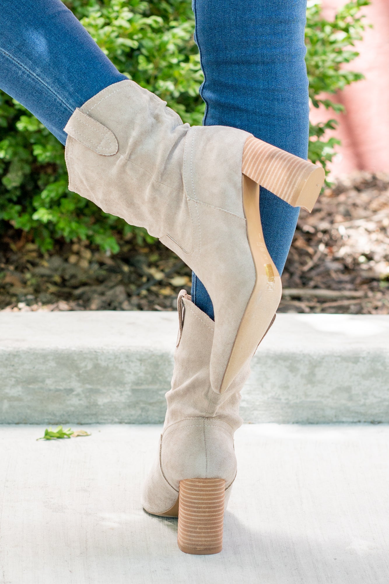 Boots by Oasis Society This city-slick cowboy-style bootie kicks it up a notch with a bold stacked heel. Crafted from manmade suede, this upper is completed with a slight slouch in the ankle. Finished on our signature padded footbed, they're a must for all day comfort. Man-made Upper Color: Taupe Padded footbed Shaft Height: 5.75" Heel Height: 3.25" Opening: 12" Contact us for any additional measurements or sizing.