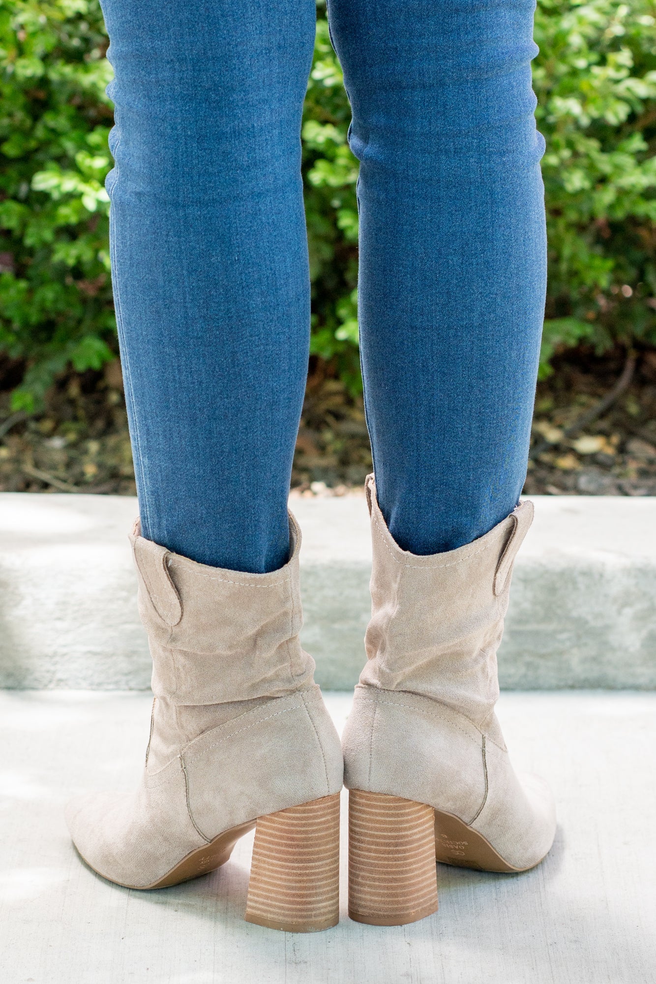 Boots by Oasis Society This city-slick cowboy-style bootie kicks it up a notch with a bold stacked heel. Crafted from manmade suede, this upper is completed with a slight slouch in the ankle. Finished on our signature padded footbed, they're a must for all day comfort. Man-made Upper Color: Taupe Padded footbed Shaft Height: 5.75" Heel Height: 3.25" Opening: 12" Contact us for any additional measurements or sizing.