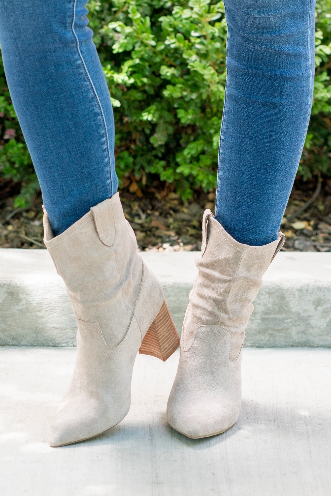 Boots by Oasis Society This city-slick cowboy-style bootie kicks it up a notch with a bold stacked heel. Crafted from manmade suede, this upper is completed with a slight slouch in the ankle. Finished on our signature padded footbed, they're a must for all day comfort. Man-made Upper Color: Taupe Padded footbed Shaft Height: 5.75" Heel Height: 3.25" Opening: 12" Contact us for any additional measurements or sizing.