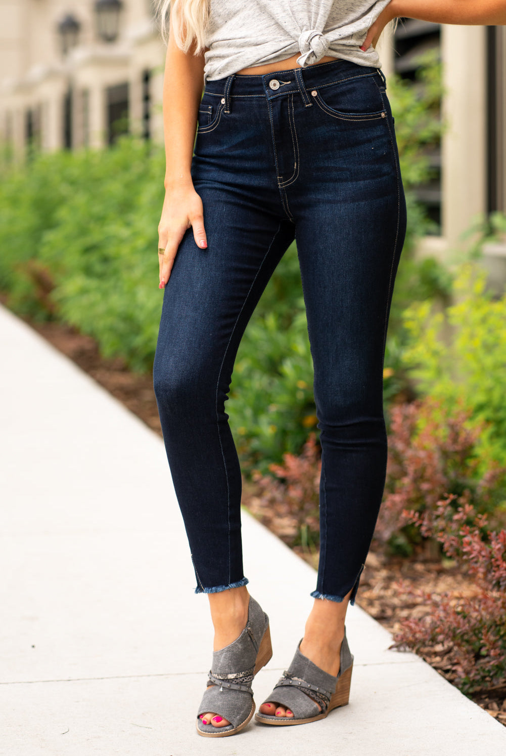KanCan Jeans These high rise dark wash skinny jeans have a spilt fray hem and fit above the ankles so you can show off you sandals this summer. Color: Dark Blue Cut: Skinny, 27.5" Inseam Rise: High-Rise, 10.5" Front Rise COTTON 71% POLYESTER 27% SPANDEX 2% Stitching: Classic Fly: Zipper Style #: KC8604D Contact us for any additional measurements or sizing. Cas is 5'7", wears a size 25 jeans, small top and 8 shoe. She is wearing a size 25/3 in these jeans.