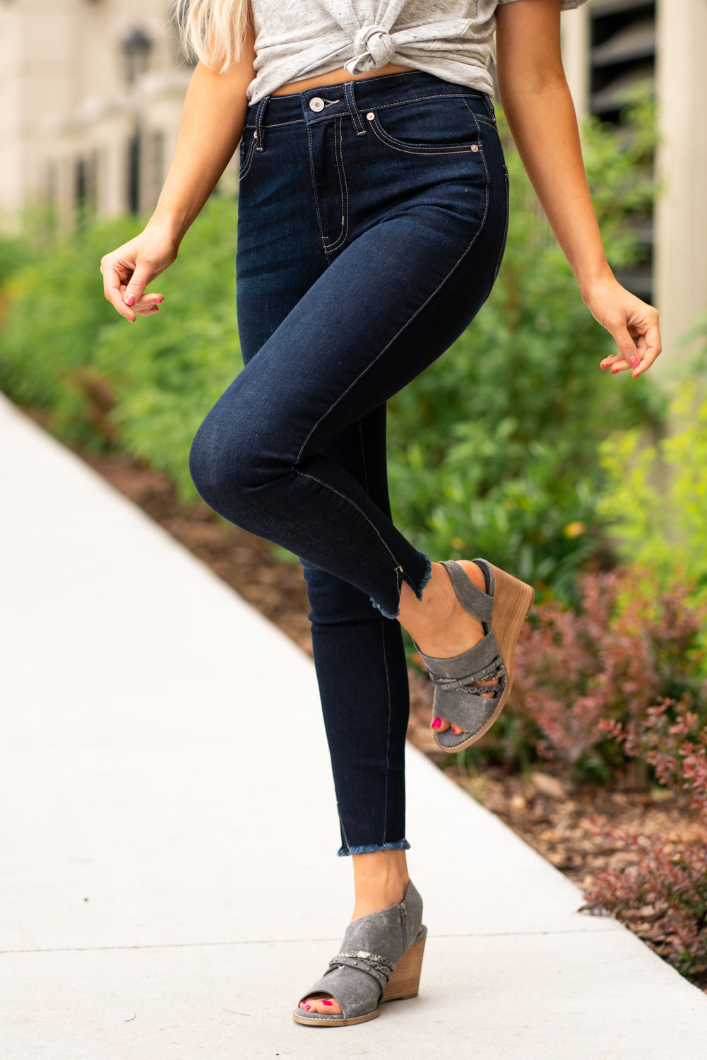 KanCan Jeans These high rise dark wash skinny jeans have a spilt fray hem and fit above the ankles so you can show off you sandals this summer. Color: Dark Blue Cut: Skinny, 27.5" Inseam Rise: High-Rise, 10.5" Front Rise COTTON 71% POLYESTER 27% SPANDEX 2% Stitching: Classic Fly: Zipper Style #: KC8604D Contact us for any additional measurements or sizing. Cas is 5'7", wears a size 25 jeans, small top and 8 shoe. She is wearing a size 25/3 in these jeans.