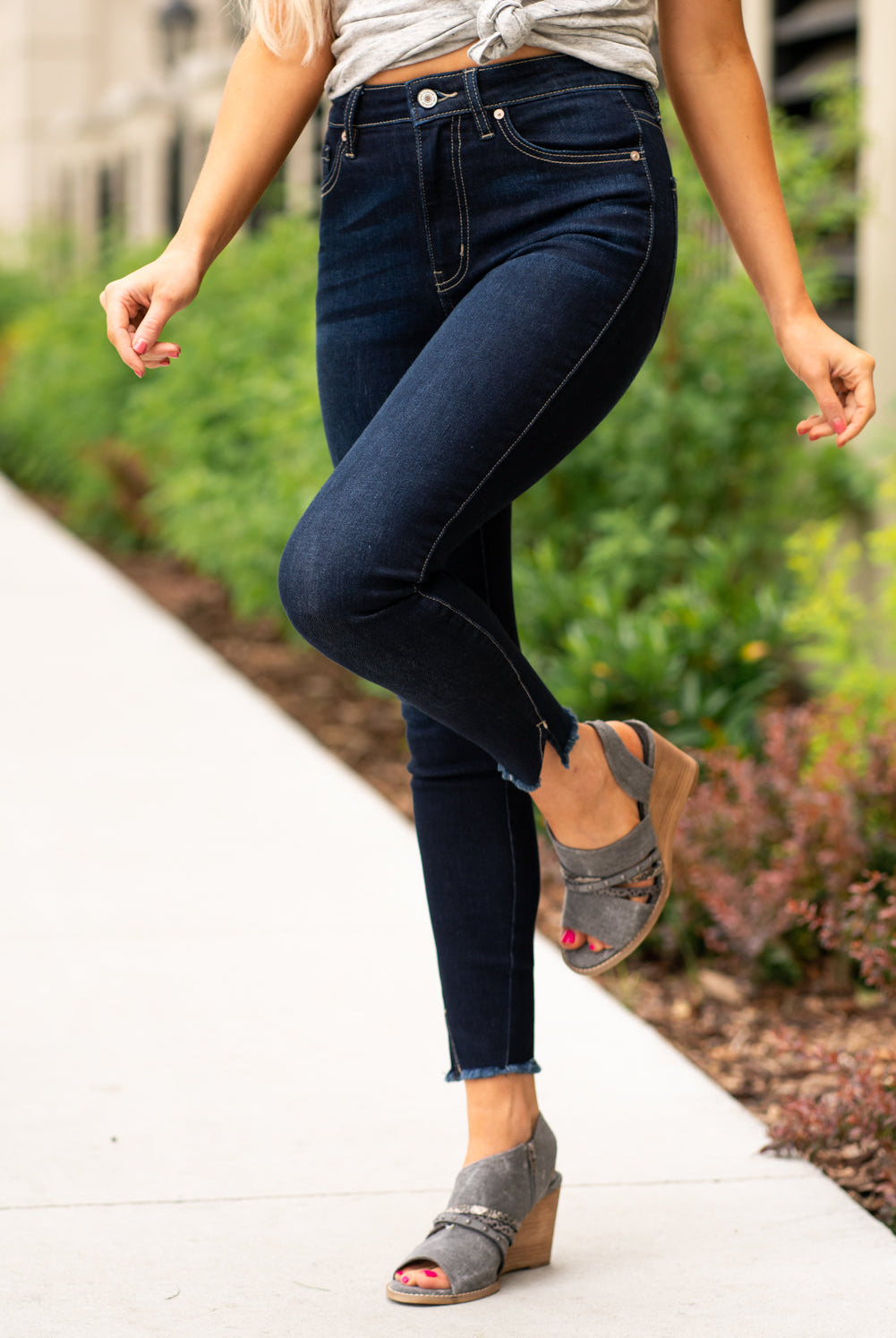 KanCan Jeans These high rise dark wash skinny jeans have a spilt fray hem and fit above the ankles so you can show off you sandals this summer. Color: Dark Blue Cut: Skinny, 27.5" Inseam Rise: High-Rise, 10.5" Front Rise COTTON 71% POLYESTER 27% SPANDEX 2% Stitching: Classic Fly: Zipper Style #: KC8604D Contact us for any additional measurements or sizing. Cas is 5'7", wears a size 25 jeans, small top and 8 shoe. She is wearing a size 25/3 in these jeans.