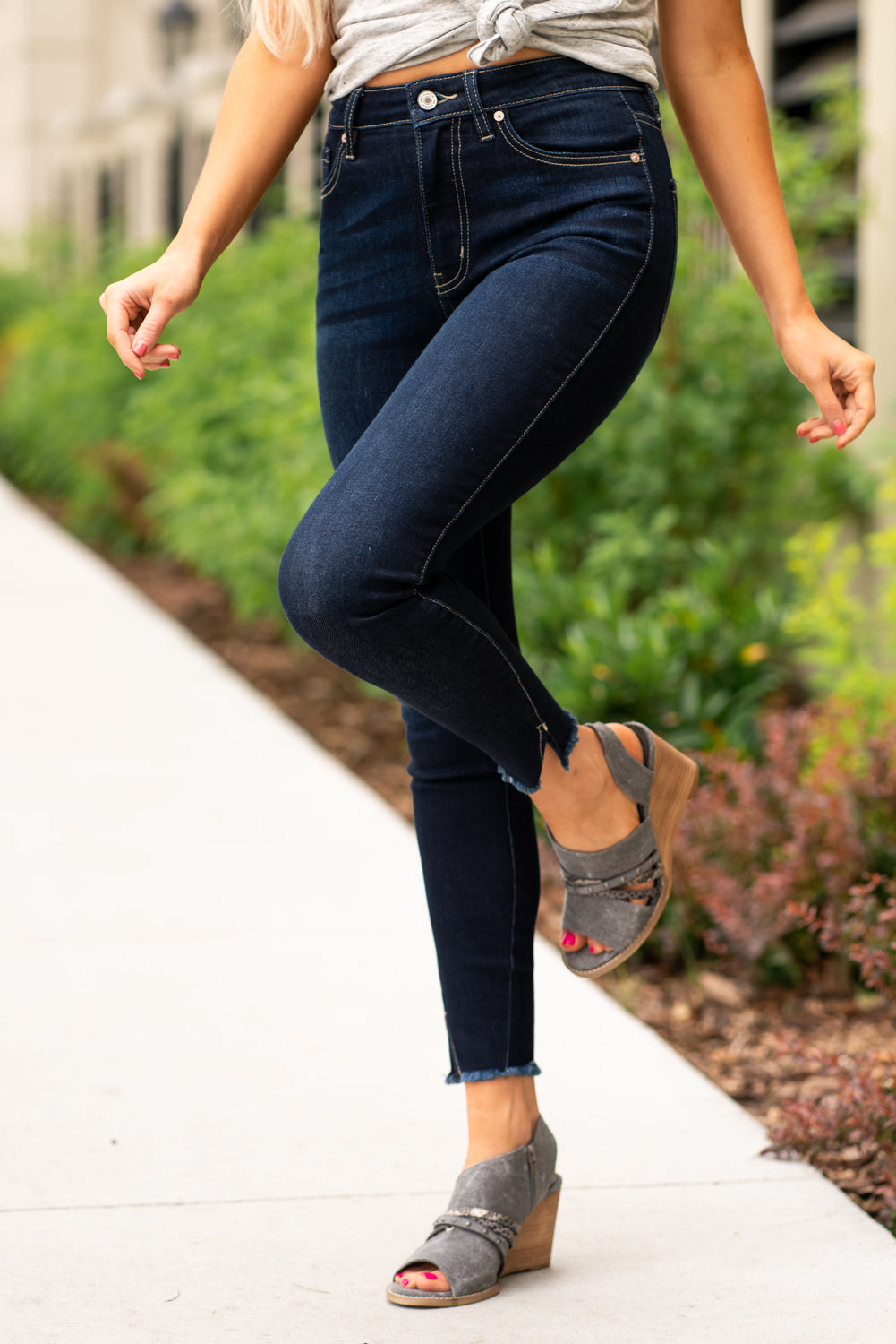 KanCan Jeans These high rise dark wash skinny jeans have a spilt fray hem and fit above the ankles so you can show off you sandals this summer. Color: Dark Blue Cut: Skinny, 27.5" Inseam Rise: High-Rise, 10.5" Front Rise COTTON 71% POLYESTER 27% SPANDEX 2% Stitching: Classic Fly: Zipper Style #: KC8604D Contact us for any additional measurements or sizing. Cas is 5'7", wears a size 25 jeans, small top and 8 shoe. She is wearing a size 25/3 in these jeans.