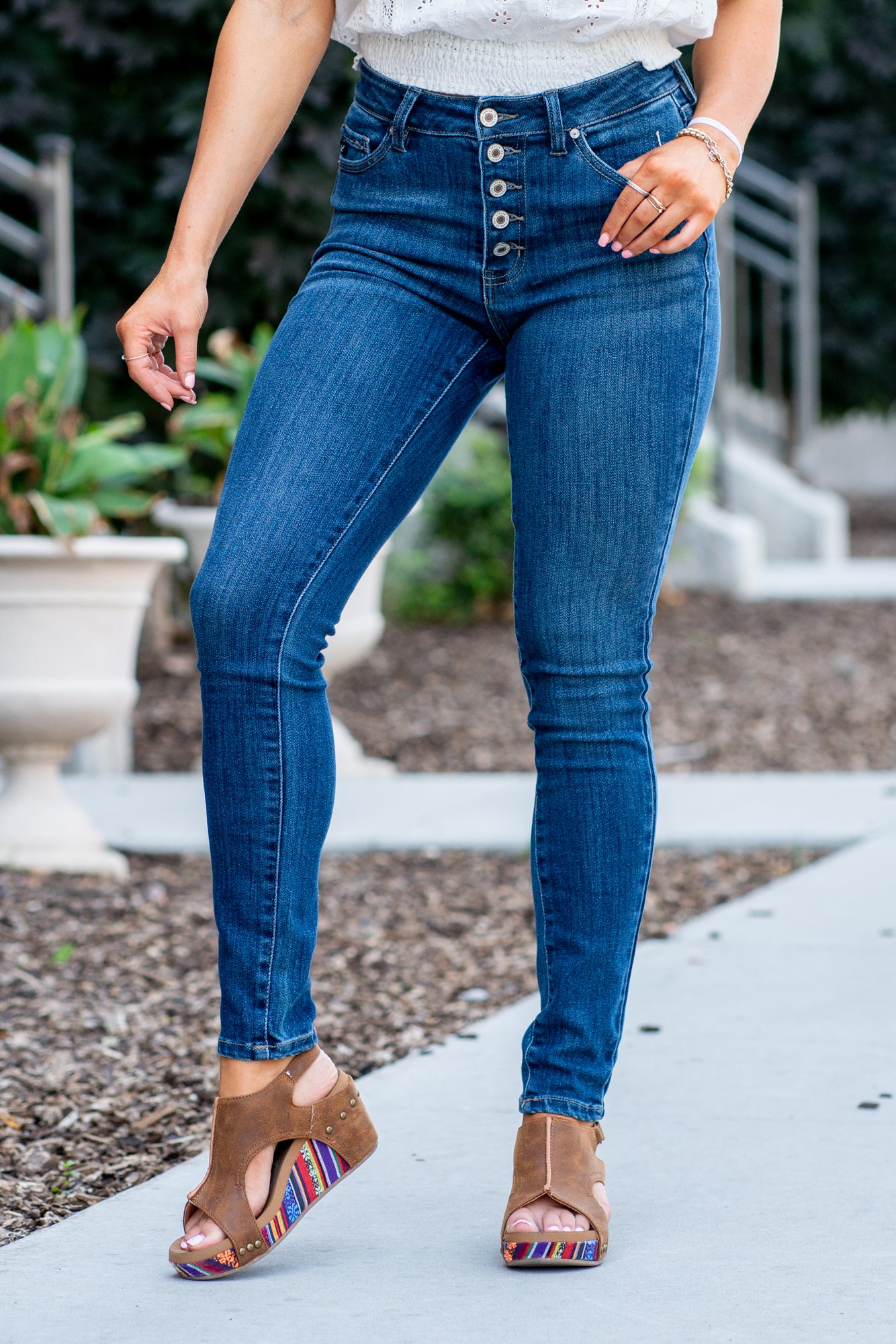 KanCan Jeans Color: Dark Wash Cut: Skinny, 30" Inseam Rise: High Rise, 10" Front Rise COTTON 67.5% POLYESTER 25% RAYON 6.5% SPANDEX 1% Stitching: Classic Fly: Exposed Button Fly Style #: KC7114RM Contact us for any additional measurements or sizing. *Measured on the smallest size, measurements may vary by size. Jacquelyn wears a size 25 in jeans, a small in tops, and 6.5 in shoes. She is wearing size 25 in these jeans.