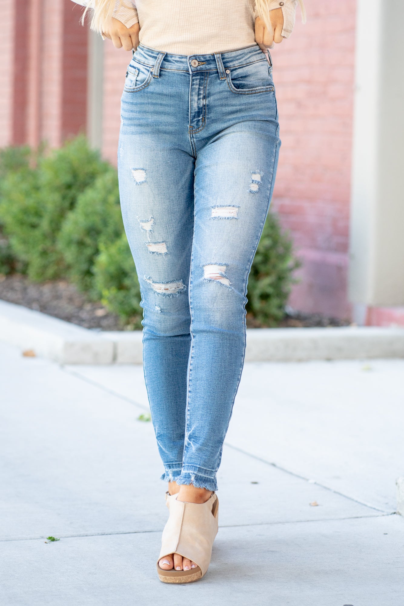 KanCan Jeans These high-rise dark wash skinny jeans have a slightly distressed hem with a fitted skinny leg. Color: Medium Blue Cut: Skinny, 29.5" Inseam* Rise: High-Rise, 9.75" Front Rise* 98% COTTON 2% SPANDEX Stitching: Classic Fly: Zipper Style #: KC8347M Contact us for any additional measurements or sizing. *Measured on the smallest size, measurements may vary by size. Cas is 5'7" and wears a size 25 in jeans, a small in tops, and 8 in shoes. She is wearing size 25 in these jeans.