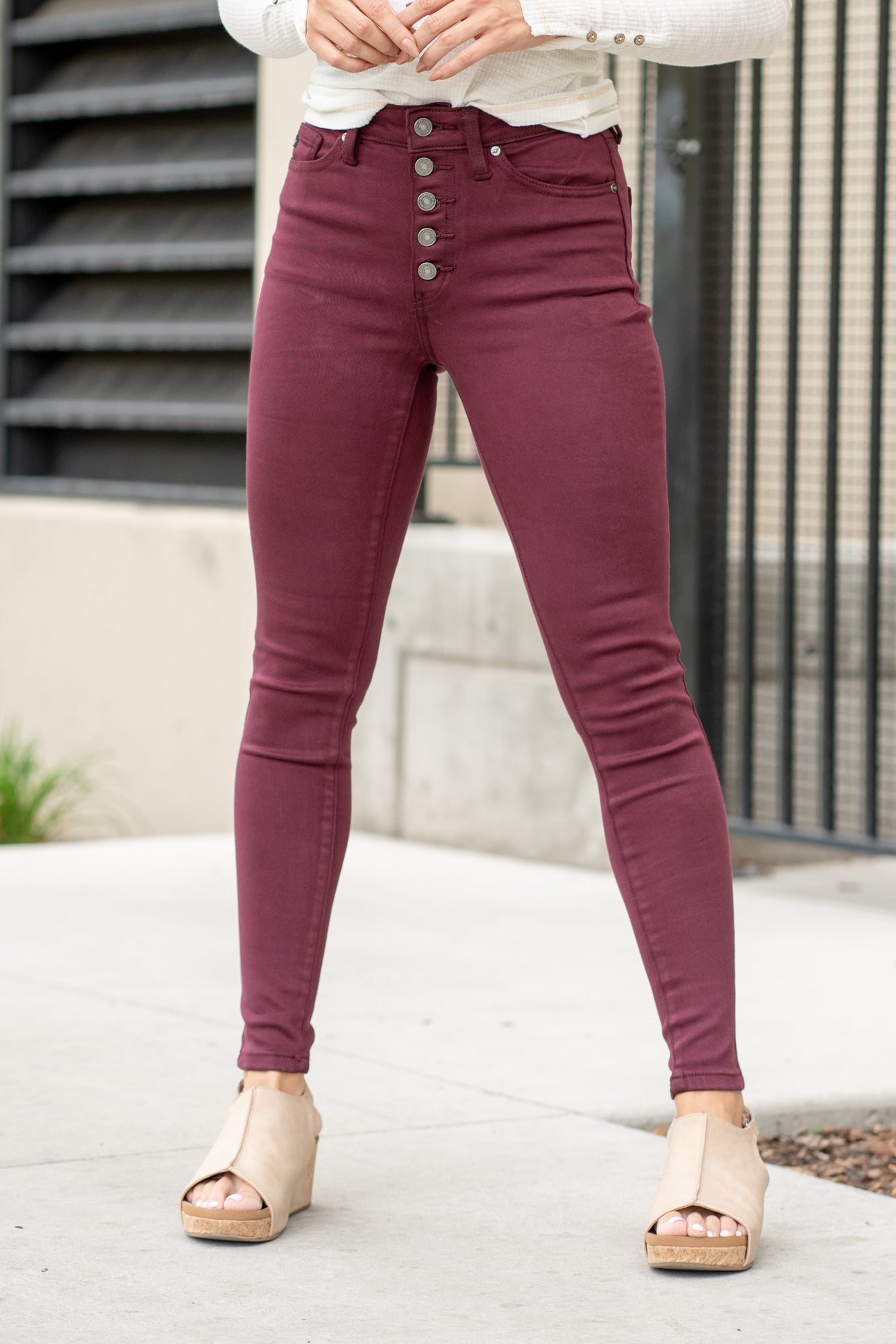 KanCan Jeans Color: Burgundy Red Cut: Super Skinny, 29" Inseam* Rise: High-Rise, 10" Front Rise* 57% COTTON, 35% MODAL, 6% POLYESTER, 2% SPANDEX Stitching: Classic Fly: Exposed Button Fly Style #: KC9252BG Contact us for any additional measurements or sizing. *Measured on the smallest size, measurements may vary by size. Alyssa wears a size 25 in jeans, a small in tops, and 8 in shoes. She is wearing size 25 in these jeans.