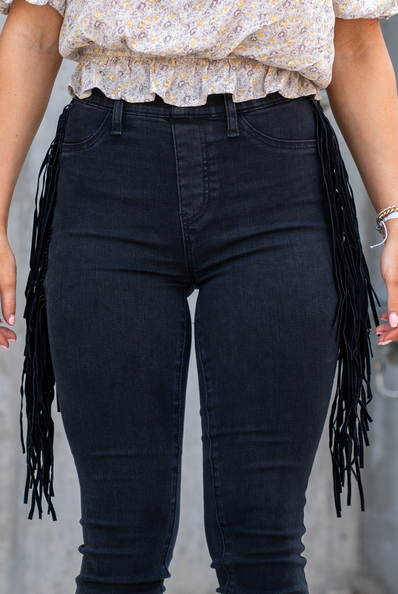 Judy Blue These pull-on jeggings have a fringe side detail and stretchy band waist. Carefully designed by Judy Blue to pull on and go. With a dark wash in black, these will be your new night-out jeans. Color: Black Cut: Pull-On Skinny, 28" Inseam* Rise: High-Rise, 10.75" Front Rise* Material: 52% Cotton, 22% Rayon, 23% Polyester, 3% Lycra Stitching: Classic Fly: Pull-On Style #: JB88497 | 88497 Contact us for any additional measurements or sizing.