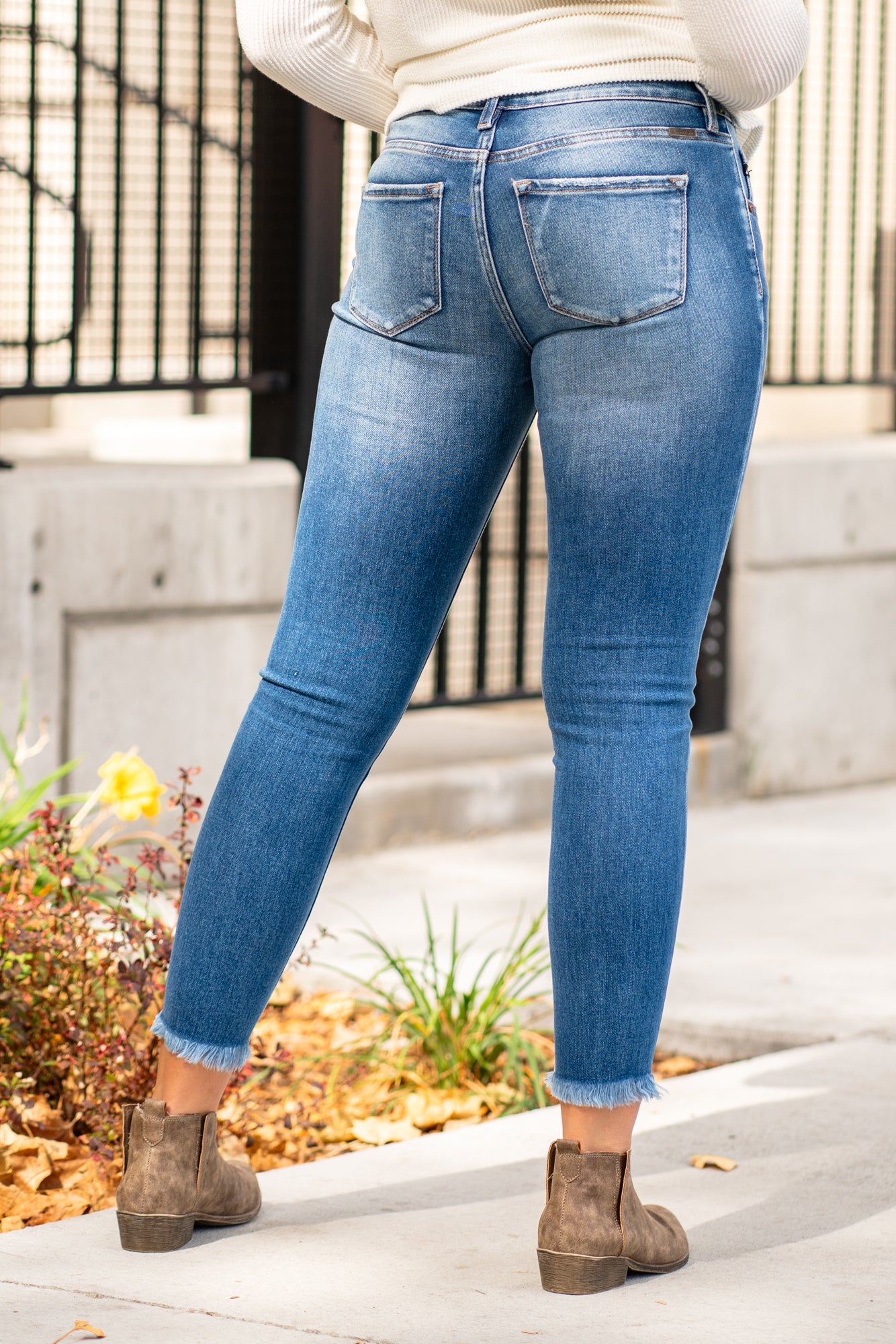 KanCan Jeans KanCan Stretchy with an asymmetrical waistband and frayed hem. Color: Medium Wash Cut: Ankle Skinny, 27" Inseam* Rise: High-Rise, 9" Front Rise* 93% COTTON , 5% POLYESTER , 2% SPANDEX Fly: Zipper Style #: KC6381M Contact us for any additional measurements or sizing. *Measured on the smallest size, measurements may vary by size.