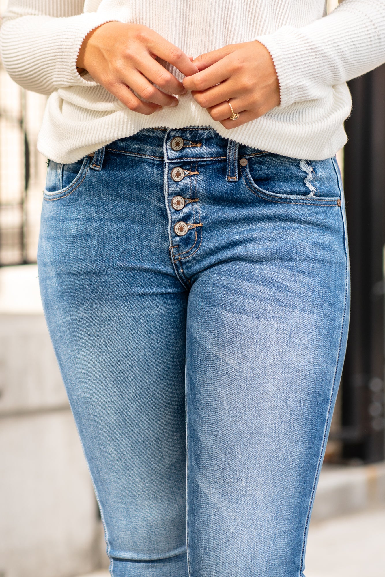 KanCan Jeans KanCan Stretchy with an asymmetrical waistband and frayed hem. Color: Medium Wash Cut: Ankle Skinny, 27" Inseam* Rise: High-Rise, 9" Front Rise* 93% COTTON , 5% POLYESTER , 2% SPANDEX Fly: Zipper Style #: KC6381M Contact us for any additional measurements or sizing. *Measured on the smallest size, measurements may vary by size.