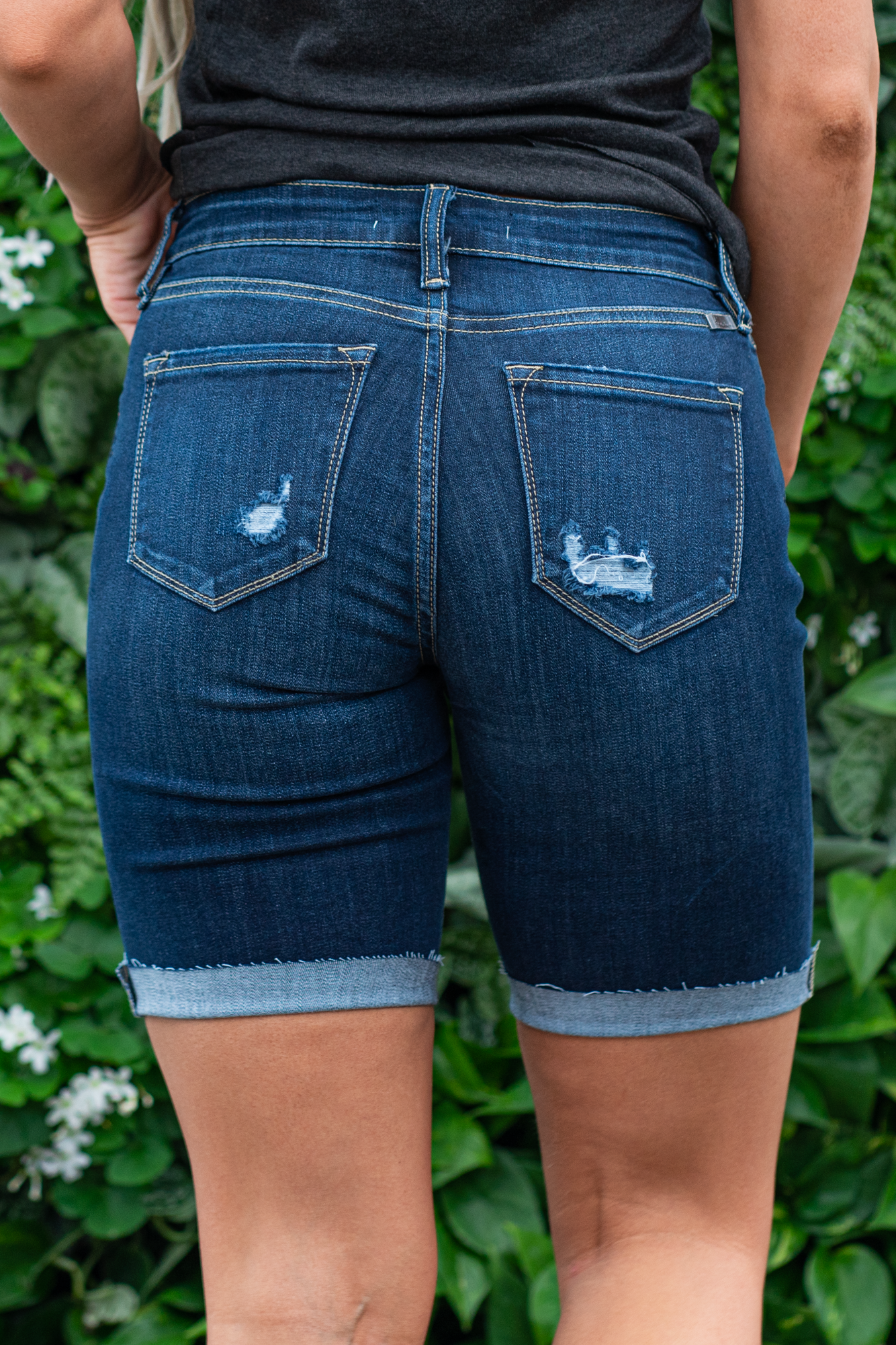 KanCan Jeans Color: Dark Wash Cuffed Mid Thigh Bermudas Cut: Mid Thigh Bermudas, 8.5" Inseam* Rise: Mid-Rise, 9" Front Rise* 64% Cotton, 21% Poly, 12% Rayon, 3% Spandex Stitching: Classic Fly: Zipper Fly Style #: KC8578D Contact us for any additional measurements or sizing. *Measured on the smallest size, measurements may vary by size.