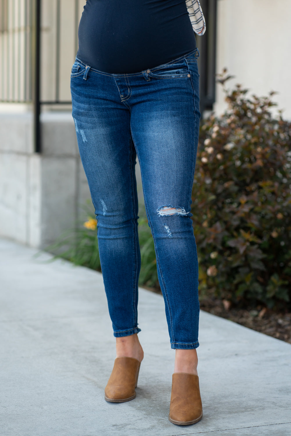 KanCan Maternity Jeans Do you miss wearing jeans? These maternity jeans will keep you comfy and cute with an elastic stretch waistband that fits just under the tummy. Color: Dark Wash Distressed Legs and Ankle Cut: Skinny, 27" Inseam Rise: Mid-Rise with Full Tummy Band, 5.5" Material: 94% COTTON, 4% T-400, 2% SPANDEX Style #: KC3018M Contact us for any sizing questions or measurements.