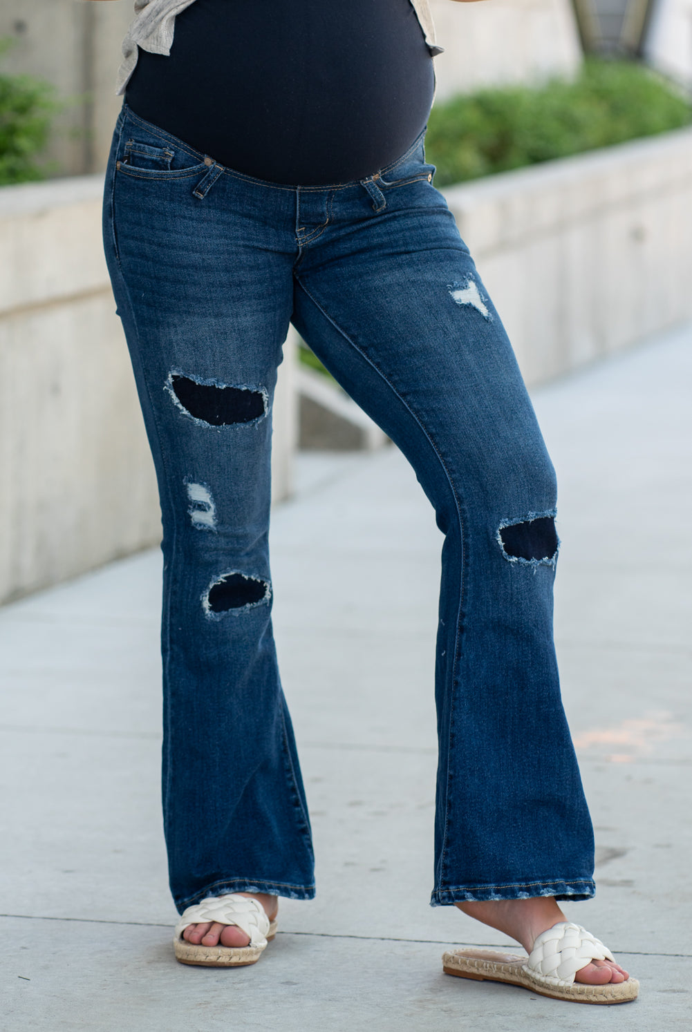 KanCan Maternity Jeans Do you miss wearing jeans? These maternity jeans will keep you comfy and cute with an elastic stretch waistband that fits over the tummy. Color: Dark Blue Wash Ripped Distressed Denim Patched Legs Fray Hem Detail Cut: Flare, 30" Inseam Rise: Mid-Rise with Full Tummy Band, 5.5" Material: 94% COTTON, 4% T-400, 2% SPANDEX Style #: KC3014D Contact us for any sizing questions or measurements.