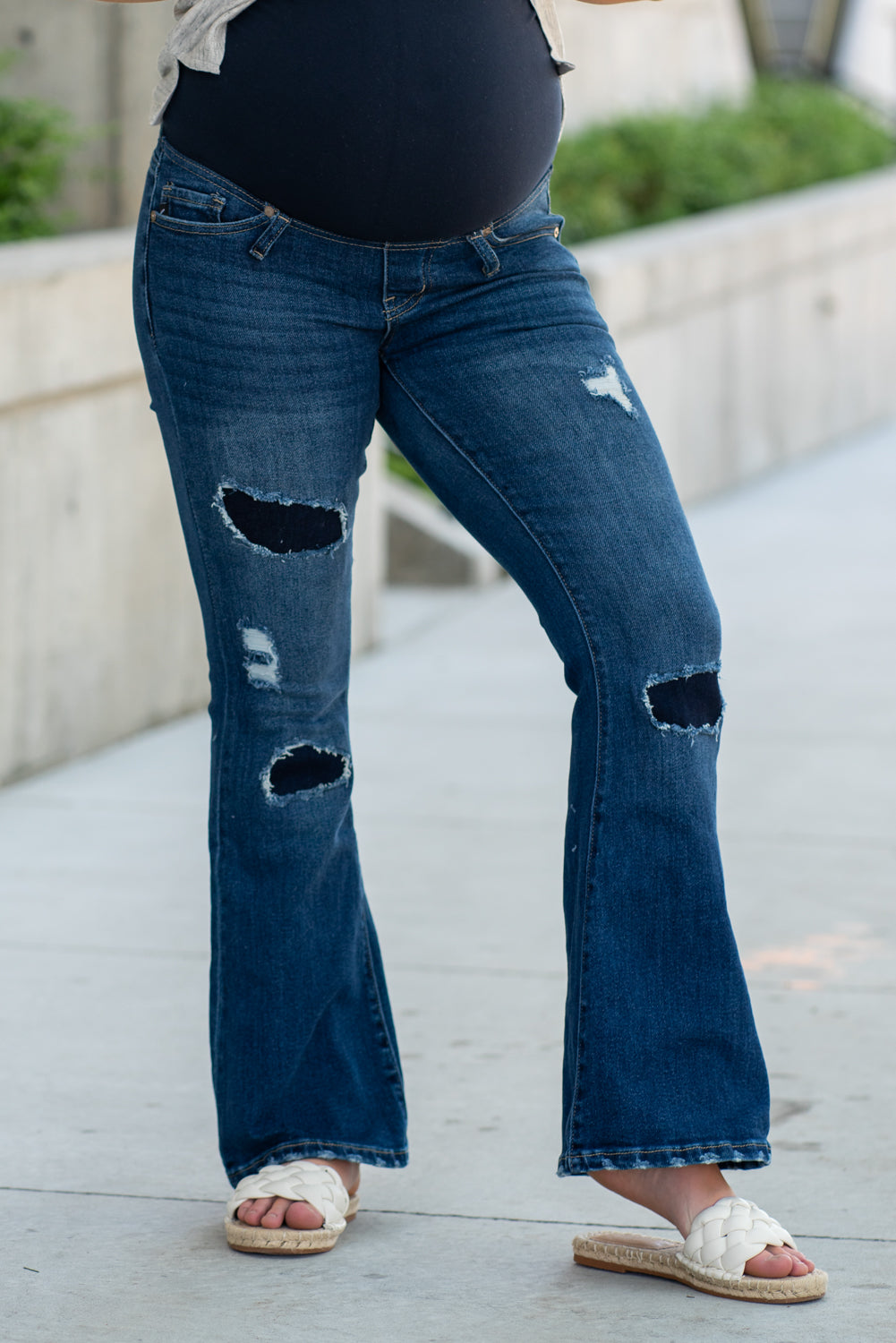 KanCan Maternity Jeans Do you miss wearing jeans? These maternity jeans will keep you comfy and cute with an elastic stretch waistband that fits over the tummy. Color: Dark Blue Wash Ripped Distressed Denim Patched Legs Fray Hem Detail Cut: Flare, 30" Inseam Rise: Mid-Rise with Full Tummy Band, 5.5" Material: 94% COTTON, 4% T-400, 2% SPANDEX Style #: KC3014D Contact us for any sizing questions or measurements.