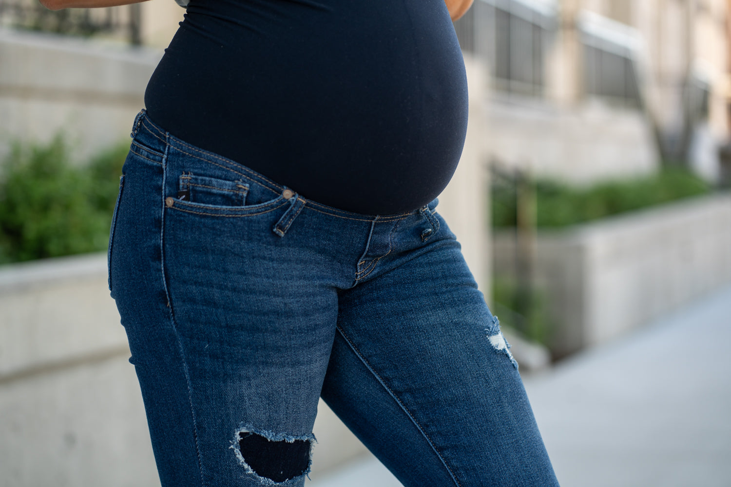 KanCan Maternity Jeans Do you miss wearing jeans? These maternity jeans will keep you comfy and cute with an elastic stretch waistband that fits over the tummy. Color: Dark Blue Wash Ripped Distressed Denim Patched Legs Fray Hem Detail Cut: Flare, 30" Inseam Rise: Mid-Rise with Full Tummy Band, 5.5" Material: 94% COTTON, 4% T-400, 2% SPANDEX Style #: KC3014D Contact us for any sizing questions or measurements.