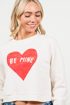 Be Mine by Oat Collective   Graphic Fleece Pullover Relaxed Fit Crop   Color: Vintage White Neckline: Round  Sleeve: Raglan Long Sleeve Spun from plush sponge fleece fabric Ribbed Cuffed Wrist Bands Oversized Pull Over Style #: OT2112L686 Contact us for any additional measurements or sizing.    