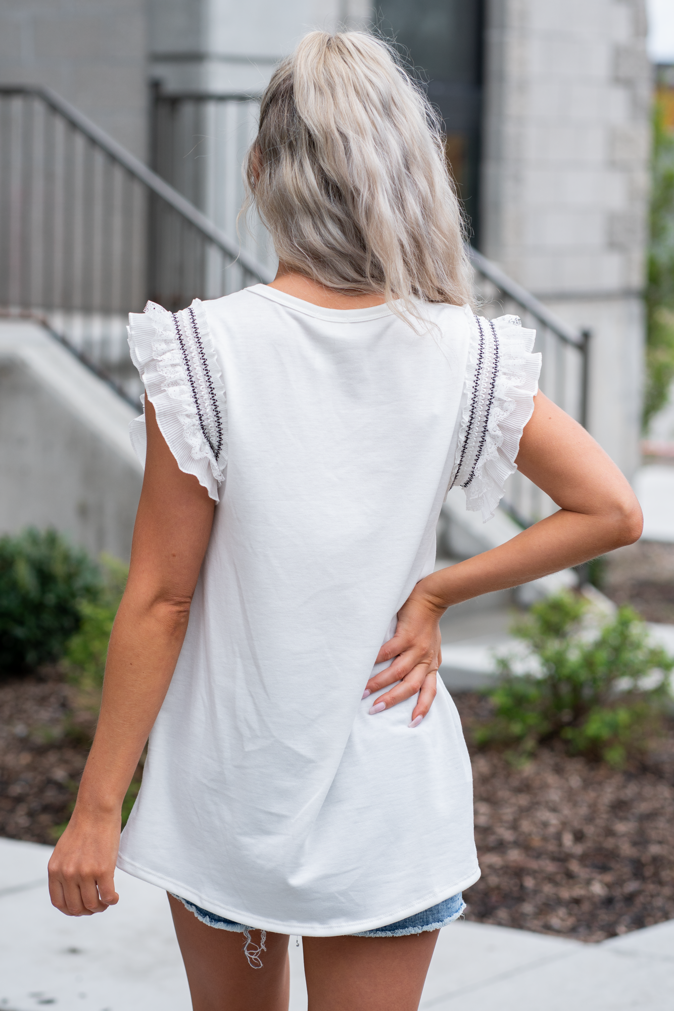 BiBi Throw on for an easy casual look with your favorite jeans. Color: Ivory Neckline: V Neck Sleeve: Sleeveless, Lace & Ruffle Lined 80% POLY 16% RAYON 4% SPAN Style #: BT1494A-01 Contact us for any additional measurements or sizing.