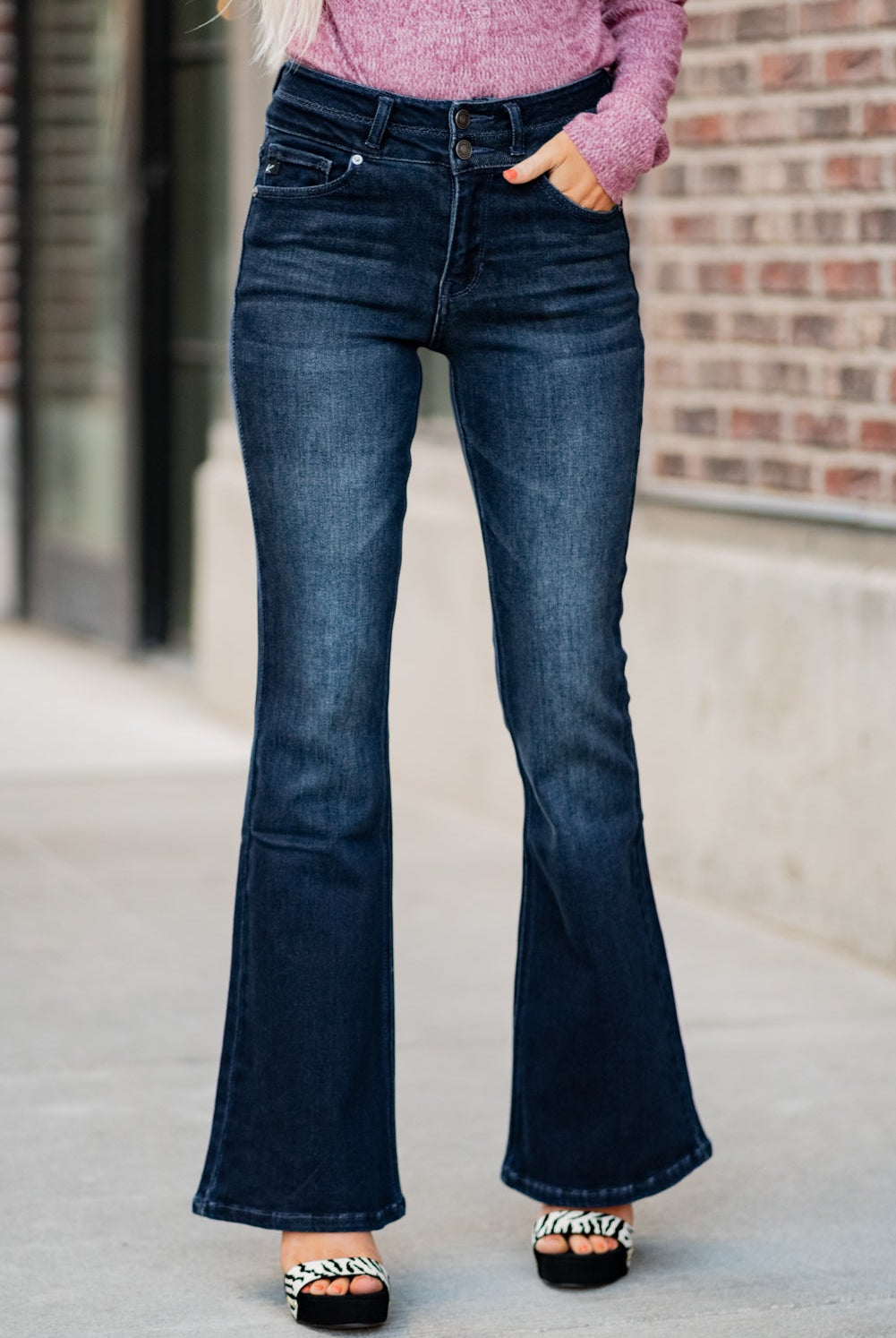 KanCan Jeans Collection: Fall 2020 Color: Dark Wash Cut: Flare Cut, 34" Inseam Rise: High-Rise, 10.5" Front Rise Material: 94% Cotton 4% Polyester2% Spandex Detail: Whisker Wash Fly: Zipper Fly with Double Button Closure Style #: KC7123D Contact us for any additional measurements or sizing. Haley is 5’6" and wears size 3 in jeans, a small top and 7.5 in shoes. She is wearing a 25 in these jeans.