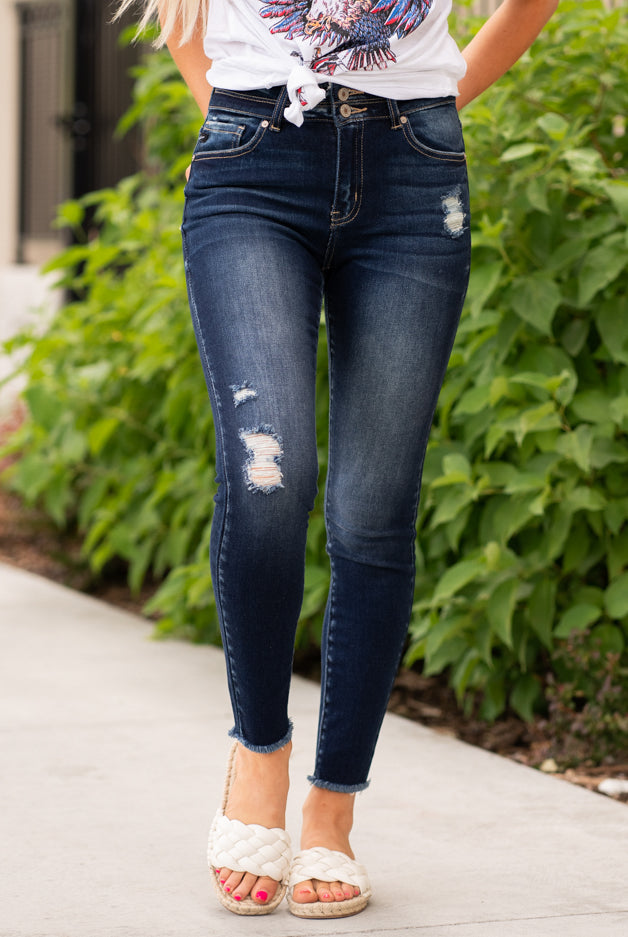 KanCan Jeans Color: Dark Wash Fray Hem Cut: Skinny, 27" Inseam Rise: High-Rise, 10" Front Rise COTTON 94.9% POLYESTER 3.8% SPANDEX 1.3% Stitching: Classic Fly: Exposed Button Fly Style #: KC7317D Contact us for any additional measurements or sizing. Haley wears a size small top, a 1 in jeans and a small in tops. She is wearing a size 24/1 in these jeans.