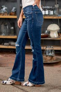 KanCan Jeans  These stretchy mid-rise flares with button-up fly will be your new favorite jeans. With a 32" inseam, you can wear them with flats all summer long.  Collection: Core Style  Flare, 32" Inseam* Mid Rise, 9.75" Front Rise* Dark Blue Wash  78% COTTON, 16% POLYESTER, 4% RAYON, 2% SPANDEX Fly: Exposed Button Fly Style #: KC6327FD-PT Contact us for any additional measurements or sizing. 