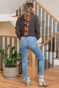 Flying Monkey  Elevate your denim game with our High Rise Distressed Hem Ankle Slim Straight Jeans. Crafted from comfortable stretch denim, these jeans feature a high-rise waist for a flattering fit. Perfect for both casual and dressed-up looks, these jeans are a must-have for any fashion-forward wardrobe.