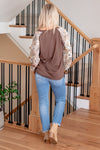 BiBi  Elevate your casual style with our Floral Sleeve French Terry Henley Top in a chic oversized brown. The floral sleeves add a touch of femininity, while the French terry fabric ensures comfort. The henley design brings a classic element, making it a versatile piece for various occasions. Whether you're running errands or enjoying a laid-back day, this oversized brown top with floral sleeves is a fashionable and comfy choice.