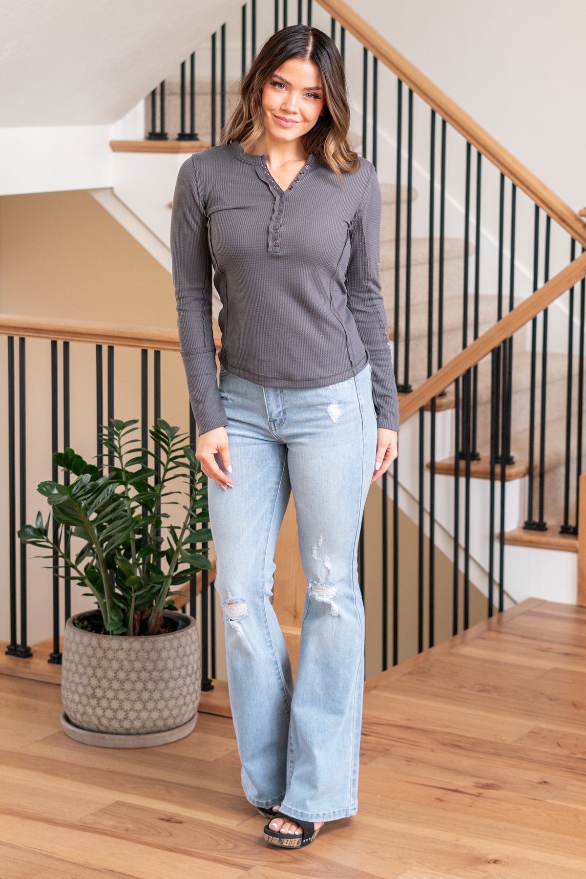 Hem & Thread   Stay both cozy and stylish with the Beth Thermal Snap Button Down Fitted Henley Top. Crafted for a snug fit, this top features a classic button-down style and thermal fabric that's perfect for cooler days.  Color: Charcoal Neckline: Open  Material: 30% Spandex 28% Acrylic 23% Nylon 19% Viscose Style #: 32676F-Charcoal