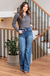 KanCan Jeans   Say hello to the Ultra High Rise Holly Flare in a dark wash. These flares feature a comfortable stretch fabric, making them a stylish and comfy. The regular hem and double waistband add unique details. These jeans are the perfect addition to any collection.  Color: Dark Wash Cut: FIT, 34" Inseam* Rise:-Rise, 11" Front Rise* Material: 75% Cotton, 23% Tencel, 2% Spandex Stitching: Classic Fly: Zipper  Style #: KC20020D