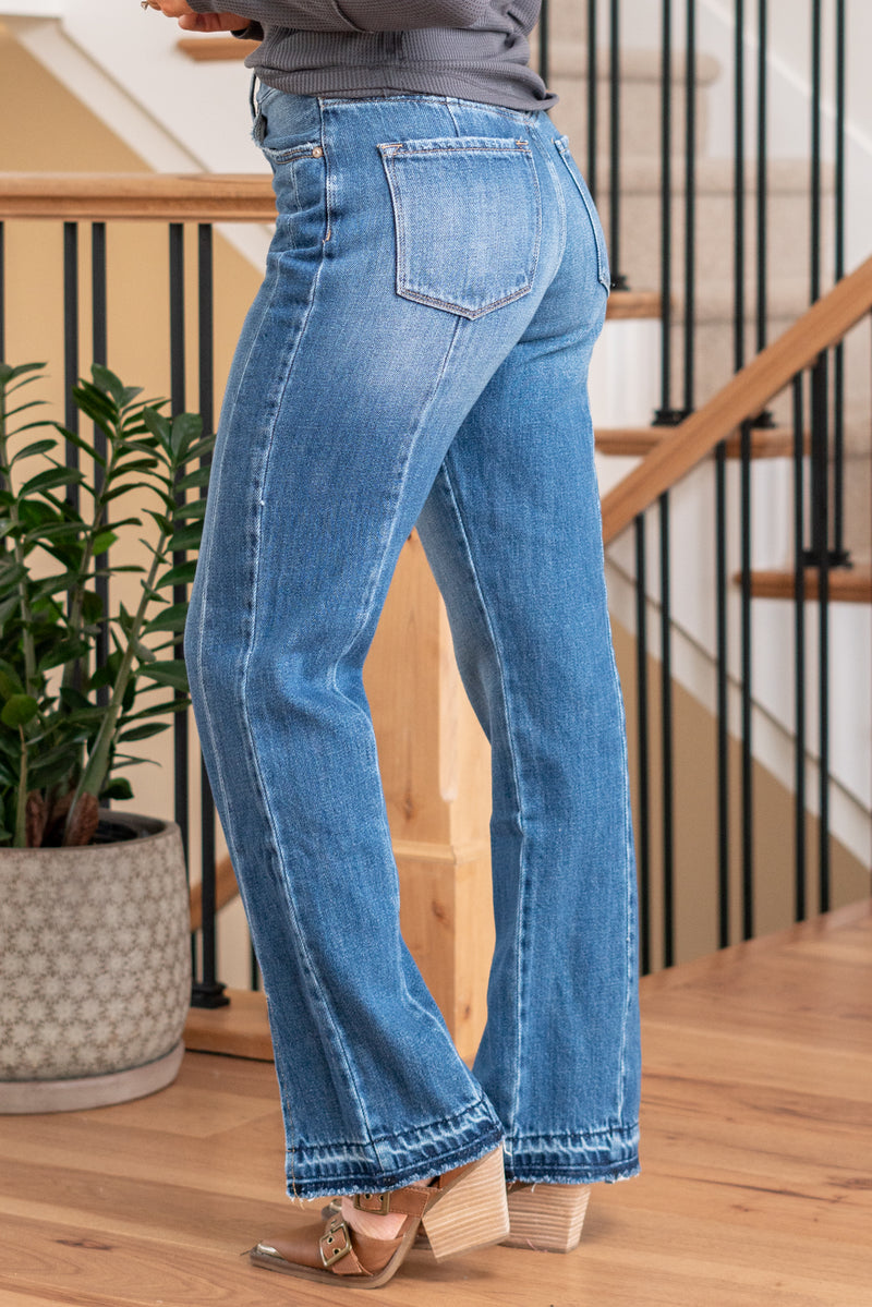 KanCan Jeans   Embrace the 90's style with these Straight Leg Jeans. With styling & feel reminiscent of the era, they come with a modern twist featuring a waist seam, cut seam, slit, and a trendy release hem. These jeans are perfect for a stylish and nostalgic look. Color: Medium Blue  Cut: Straight, 31" Inseam* Rise:-Rise, 11 3/4" Front Rise* Material: 100% Cotton, Rigid Denim Stitching: Classic Fly: Zipper  Style #: KC8721M