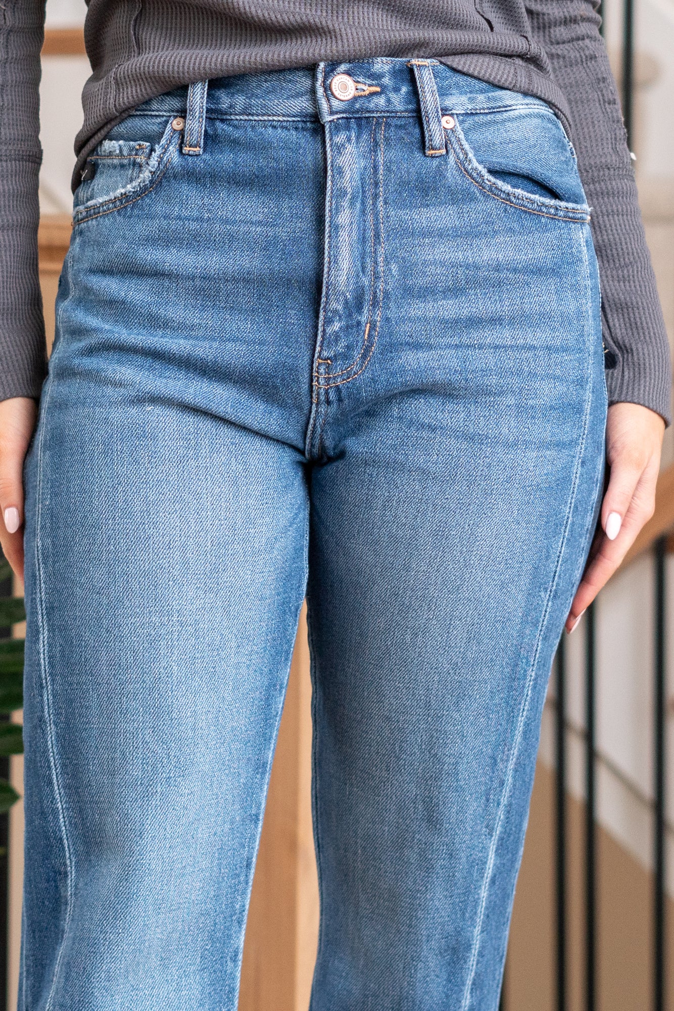 KanCan Jeans   Embrace the 90's style with these Straight Leg Jeans. With styling & feel reminiscent of the era, they come with a modern twist featuring a waist seam, cut seam, slit, and a trendy release hem. These jeans are perfect for a stylish and nostalgic look. Color: Medium Blue  Cut: Straight, 31" Inseam* Rise:-Rise, 11 3/4" Front Rise* Material: 100% Cotton, Rigid Denim Stitching: Classic Fly: Zipper  Style #: KC8721M