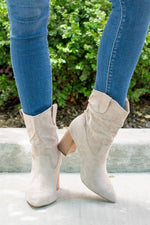 Boots by Oasis Society  This city-slick cowboy-style bootie kicks it up a notch with a bold stacked heel. Crafted from manmade suede, this upper is completed with a slight slouch in the ankle. Finished on our signature padded footbed, they're a must for all day comfort.  Man-made Upper Color: Taupe Padded footbed Shaft Height: 5.75" Heel Height: 3.25" Opening: 12" Contact us for any additional measurements or sizing. 