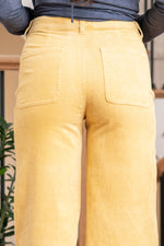 KanCan Jeans   Ultra High Rise Wide Leg Jeans in a vibrant mustard color. Crafted from stretch fabric, these jeans offer both comfort and a trendy look. They feature a zipper fly, unique patched pocket details, and back darts for added style. Color: Mustard Yellow Cut: FIT, 32" Inseam* Rise:-Rise, 11" Front Rise* Material: 97% Cotton, 3% Spandex Stitching: Classic Fly: Zipper  Style #: KC2086MT