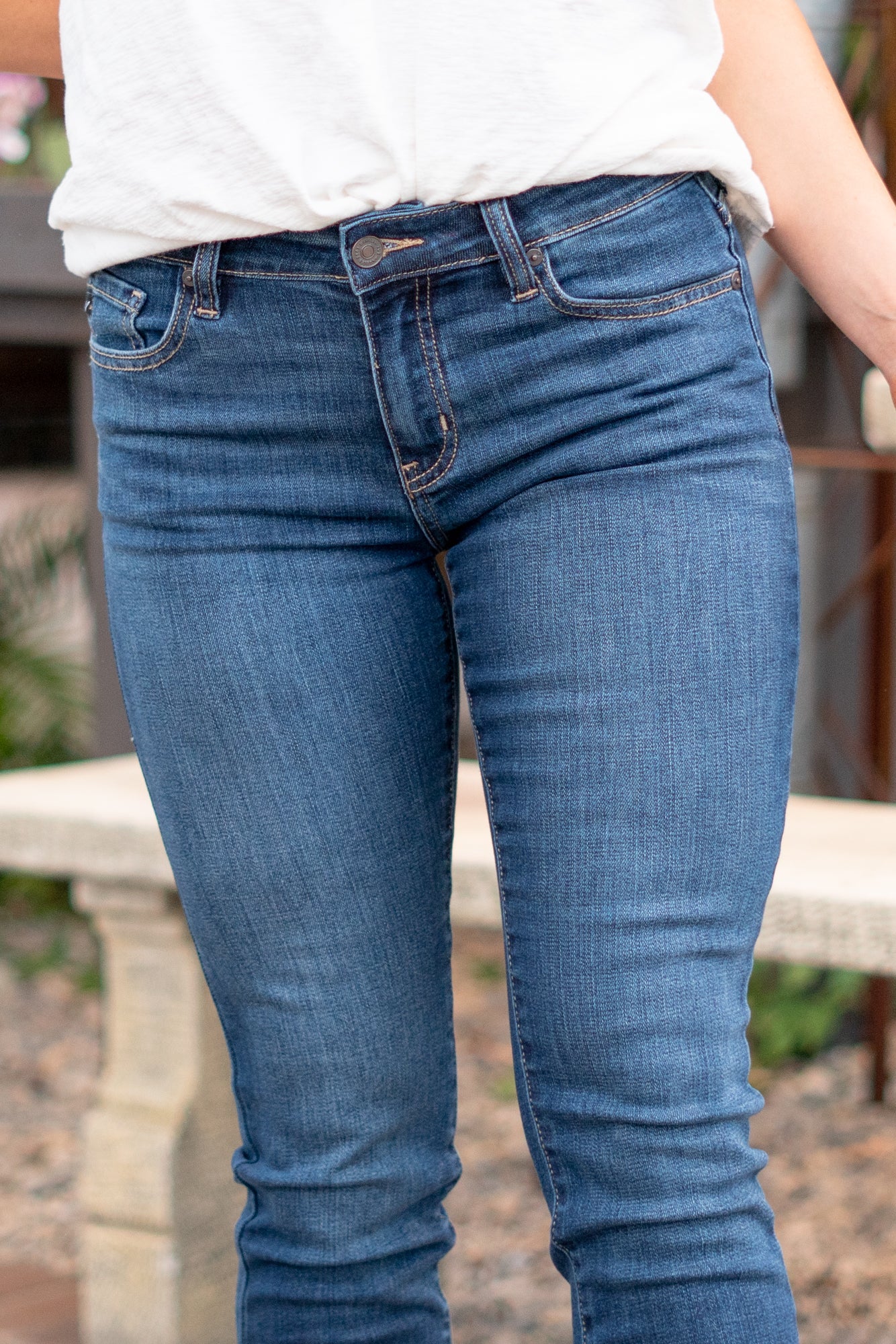 KanCan Jeans Color: Dark Wash Cut: Skinny, 27" Inseam* Rise: Mid-Rise, 9" Front Rise* 74% COTTON, 10% RAYON, 15% POLYESTER, 1% SPANDEX Stitching: Classic Fly: Zipper Style #: KC20009D Contact us for any additional measurements or sizing.  *Measured on the smallest size, measurements may vary by size.  Jacquelyn wears a size 25 in jeans, a small in tops, and 6.5 in shoes. She is wearing size 25 in these jeans.