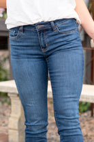 KanCan Jeans Color: Dark Wash Cut: Skinny, 27" Inseam* Rise: Mid-Rise, 9" Front Rise* 74% COTTON, 10% RAYON, 15% POLYESTER, 1% SPANDEX Stitching: Classic Fly: Zipper Style #: KC20009D Contact us for any additional measurements or sizing.  *Measured on the smallest size, measurements may vary by size.  Jacquelyn wears a size 25 in jeans, a small in tops, and 6.5 in shoes. She is wearing size 25 in these jeans.