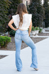 American Blues KanCan Jeans  Elevate your denim collection with our Classic Flared Jeans featuring knee destruction and a tattered hem. These jeans effortlessly blend edgy and chic, giving you a tattered look that makes a statement. Sitting right at the natural waistline, they gently taper down the thigh and then flare out at the calf, ensuring a flattering silhouette. 