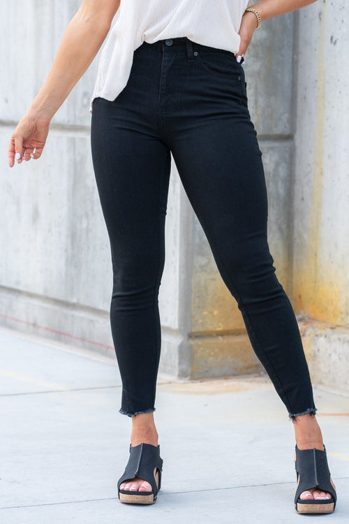KanCan Jeans  These high rise medium wash skinny jeans have a spilt fray hem and fit above the ankles so you can show off you sandals this summer. Color: Black Cut: Skinny, 26.5" Inseam Rise: High-Rise, 10.5" Front Rise 72%COTTON, 25% POLYESTER, 3% SPANDEX Stitching: Classic Fly: Zipper Style #: KC8604BBK Contact us for any additional measurements or sizing.