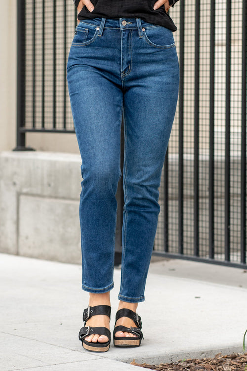 KanCan Jeans  With a high waist and straight fit, these will be your go-to jeans that will never go out of style. Color: Dark Blue  Cut: Straight Fit, 28.5" Inseam* Rise: High-Rise, 11" Front Rise* COTTON 75%, TENCEL 23%,SPANDEX 2% Fly: Zipper Style #: KC11252D Contact us for any additional measurements or sizing.   *Measured on the smallest size, measurements may vary by size.  Sarah wears a size 25 in jeans, a small in tops, and 8 in shoes. She is wearing size 25 in these jeans. 