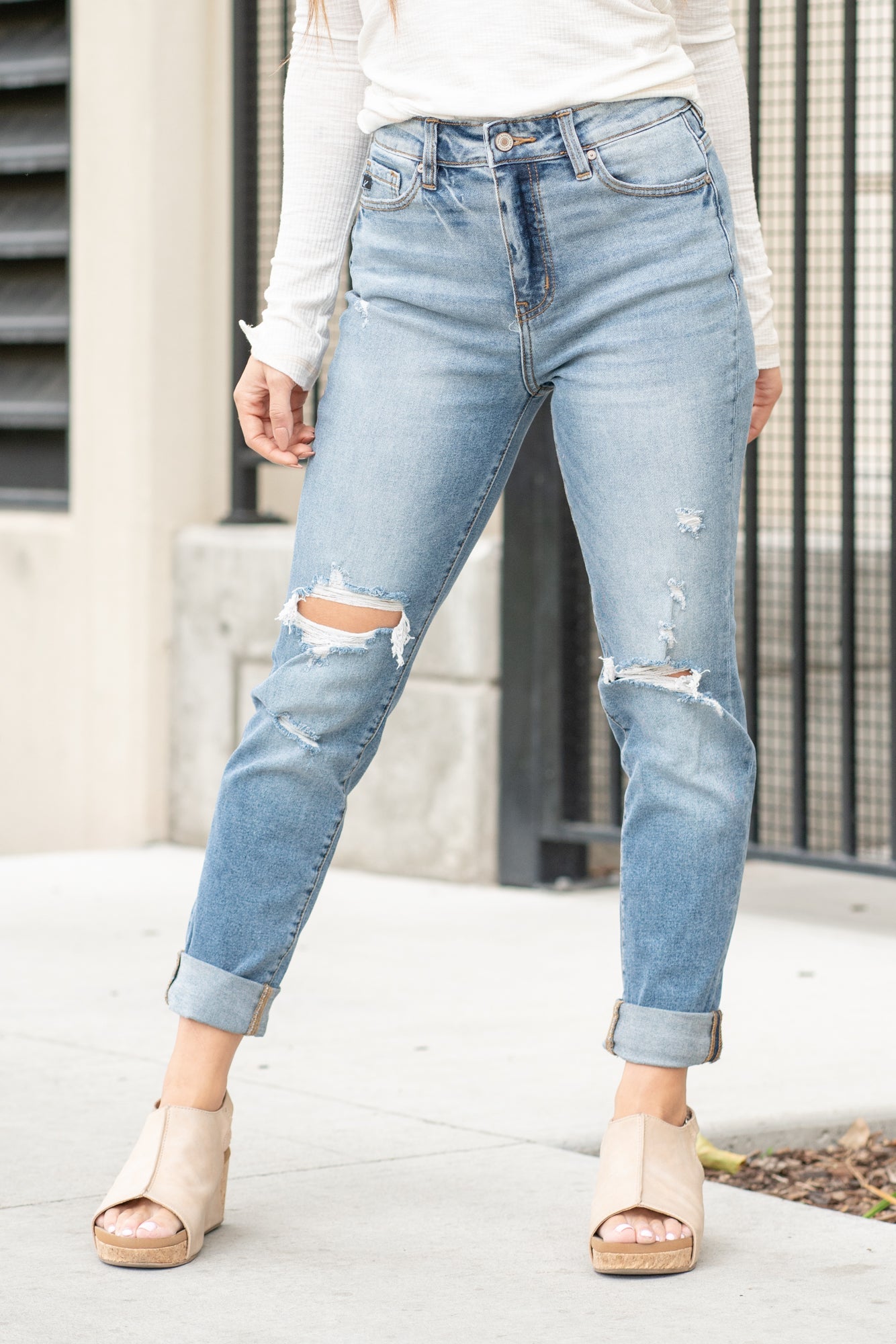 KanCan Jeans  These mom jeans will become your go-to! Pair these girlfriend mom fit with booties and a tee for an easy fall look.  Color: Medium Blue Wash Cut: Straight Fit, 30" Inseam* Rise: High-Rise, 11" Front Rise* 99% COTTON 1% SPANDEX Fly: Zipper Style #: KC8403D Contact us for any additional measurements or sizing.  *Measured on the smallest size, measurements may vary by size.  Alyssa wears a size 25 in jeans, a small in tops, and 8 in shoes. She is wearing size 3 in these jeans.