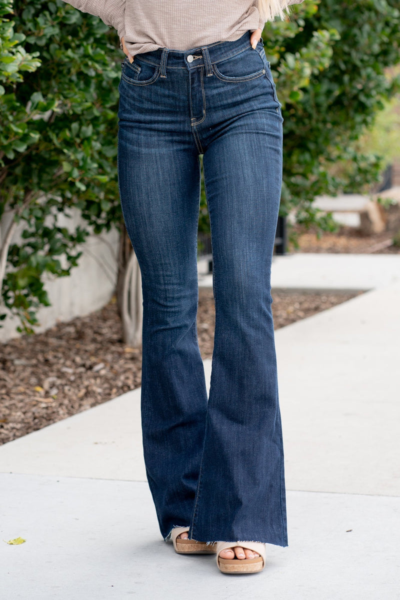 Judy Blue  Don't be afraid to wear high-waisted jeans, especially these flares. With a dark blue wash and a cut hem detail, these will be your favorite denim to dress up. Color: Dark Blue Wash Cut: Flare, 34" Inseam* Rise: High-Rise. 10.75" Front Rise* Material: 52% Cotton / 23% Polyester / 22% Rayon / 3% Spandex Stitching: Classic  Fly: Zipper Style #: JB82343 | 82343 *Measured on the smallest size, measurements may vary by size.  Contact us for any additional measurements or sizing.