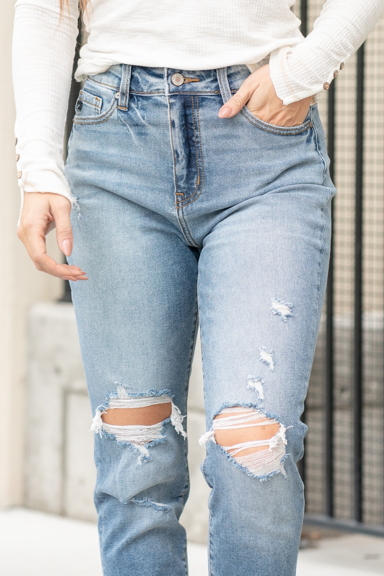 KanCan Jeans  These mom jeans will become your go-to! Pair these girlfriend mom fit with booties and a tee for an easy fall look.  Color: Medium Blue Wash Cut: Straight Fit, 30" Inseam* Rise: High-Rise, 11" Front Rise* 99% COTTON 1% SPANDEX Fly: Zipper Style #: KC8403D Contact us for any additional measurements or sizing.  *Measured on the smallest size, measurements may vary by size.  Alyssa wears a size 25 in jeans, a small in tops, and 8 in shoes. She is wearing size 3 in these jeans.