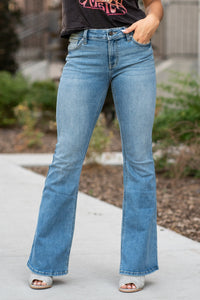 KanCan Jeans  Don't be afraid to wear flares again, not when they look this good! These mid-rise flare jeans hit at exactly the right spot on your waist and with some spandex, these will stretch as you wear and get super comfy!   KanCan Stretch Level: Comfort Stretch   Collection: Core Style  Color: Light Blue Wash Cut: Flare, 33.75" Inseam  Rise: Mid-Rise, 9" Front Rise 68% COTTON , 30% POLYESTER , 2% SPANDEX Fly: Zipper Style #: KC6102TL Contact us for any additional measurements or sizing. 