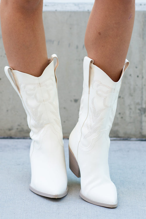 Boots by Oasis Society  Beautifully embroidered and intricately detailed, this boot is that perfect amount of fashionable, the Western without the ruggedness. Color: White Man-made Upper  Insole Material: Padded Insole Heel Material: Leather wrap heel Slip On Shaft Height: 8.25" Heel Height: 2.25"' Front Platform: .25" Circumference of shoe opening: 15" Contact us for any additional measurements or sizing. 