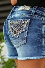 Miss Me Jeans  Collection: Spring 2020 Name: Sunburst Color: Medium Wash Cut: Shorts, 3.5" Inseam Rise: Mid Rise, 8.75" Front Rise 93% Cotton 6% Polyester 1% Elastane Stitching: Classic Fly: Zipper Style #: M3530H